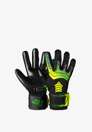 Guanti da portiere con palmo in lattice nero, dorso testurizzato verde e nero, cinturino regolabile al polso e dettagli di marca ben visibili.