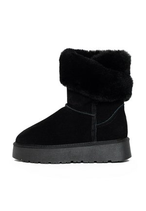 Black suede ankle boot with a fold-over faux fur collar, flat rubber sole, and contrasting stitching details. Smooth texture, rounded toe design.