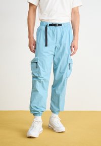 Nike Sportswear TECH WOVEN - Cargo trousers - denim turquoise/black