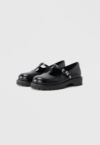Black leather shoes with a rounded toe, cut-out side, and adjustable buckle strap. Thick, textured sole adds stability.