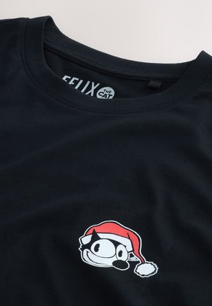Mustapaitainen T-paita, jossa on valkoisella ja punaisella brodeeratun Felix the Cat -kuvion, jonka päällä on joulupaita. Paidan kaula-aukko on pyöreä ja siinä on lyhyet hihat.