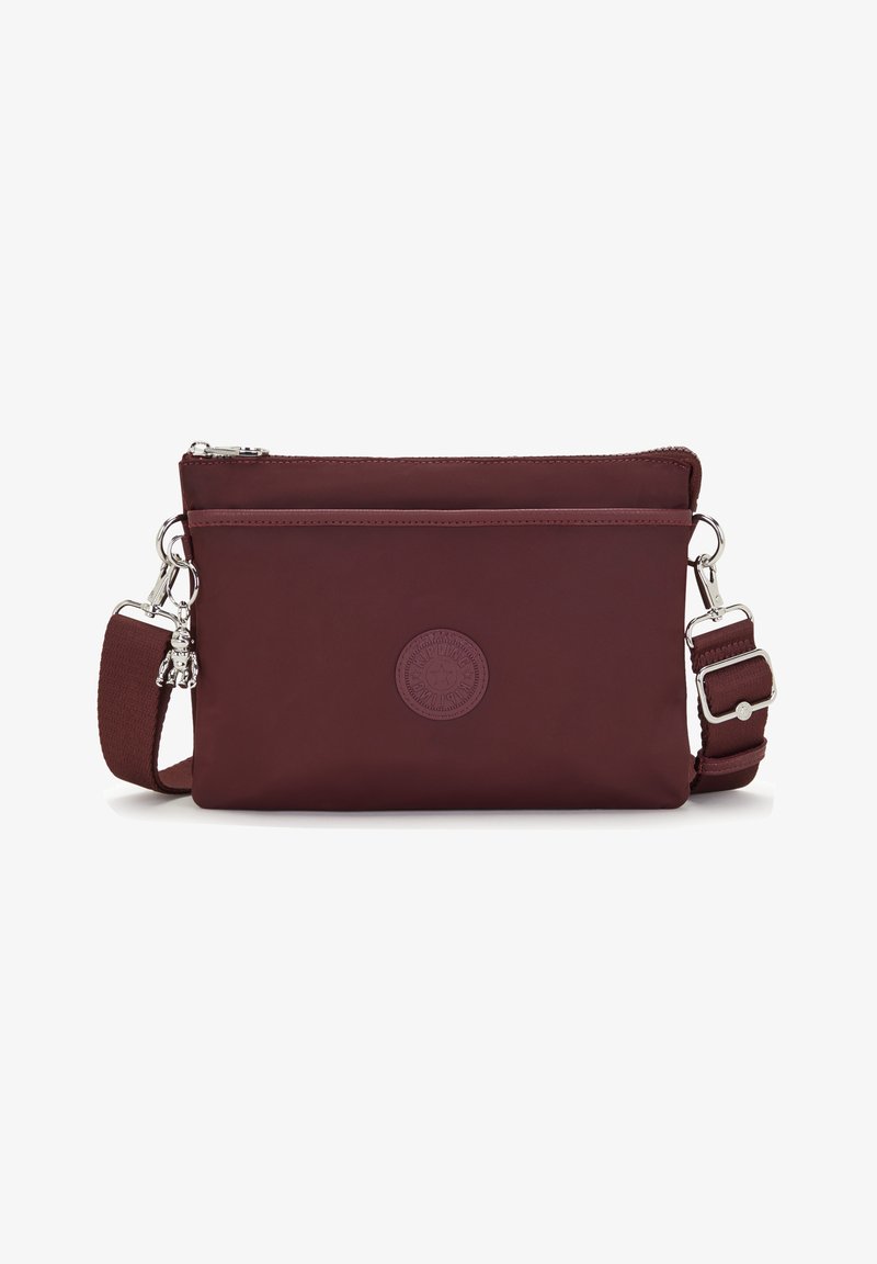 Burgundy crossbody bag made of nylon with a smooth texture. Features a zipper closure, adjustable strap, and embossed logo detail.