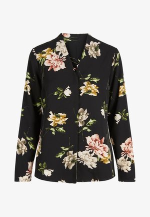 Zwarte blouse met lange mouwen en grote bloemenprint in wit, geel, roze en groene bladeren, met een V-hals en losse pasvorm.