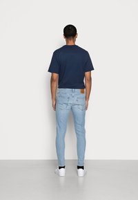 Levi's® SKINNY TAPER - Calças de ganga de corte skinny - corfu lucky day