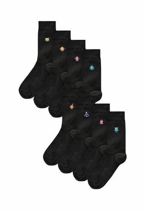 Black cotton crew socks featuring seven pairs, each with unique colorful monster designs embroidered on the ankle. Soft texture, regular fit.