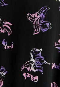 Cotton fabric with a black background featuring large, abstract butterflies in shades of purple and pink, creating a bold graphic pattern.