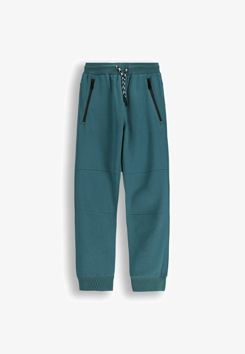 Ciemnoniebieskie spodnie dresowe wykonane z miękkiego, teksturowanego materiału. Posiadają czarne zamki błyskawiczne w bocznych kieszeniach oraz prążkowane mankiety przy kostkach.