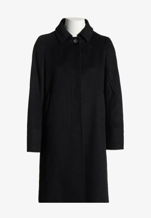 Long manteau en laine noire avec col, un seul bouton visible au niveau du cou, et fermeture avant dissimulée sur un mannequin blanc.