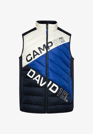 Vaatimaton sansihihaton liivi, jossa on väriblokkikuvio navy, sinisessä ja valkoisessa, suurilla tekstigraafeilla. Vetoketjullinen etuosa ja korkea kaulus.