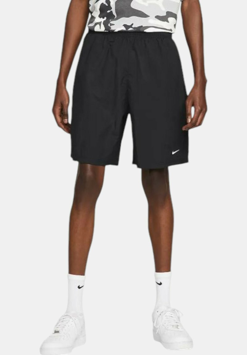 Black athletic shorts with an elastic waistband, made of lightweight material, featuring a small white Nike logo on the lower left side.