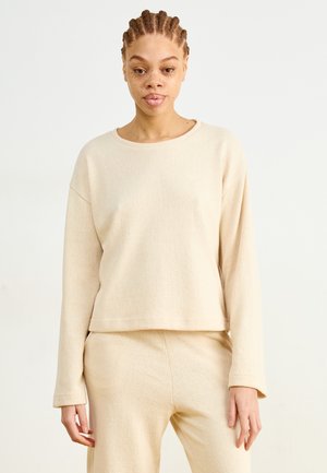 Beige lange mouw top van textiel met structuur, met een wijde halslijn en een ontspannen pasvorm, gecombineerd met bijpassende beige broek.