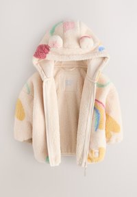 Veste à capuche crème en tissu duveteux avec des motifs colorés, comprenant des formes jaunes et roses ainsi qu'un arc-en-ciel, dotée d'une fermeture éclair à l'avant et de pompons en guise de détails.