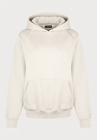Sudadera con capucha de color beige claro, con bolsillo canguro, puños y dobladillo acanalados y capucha con cordones. Tela suave y texturizada con detalle de acento en el hombro.