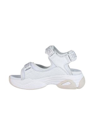 Las sandalias deportivas blancas presentan un diseño de malla, correas ajustables y una suela de goma gruesa con acentos texturizados para ofrecer agarre y soporte.