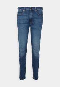 Jeans blu scuri in denim, caratterizzati da una vestibilità slim, cinque tasche e chiusura a bottoni. Il tessuto presenta una leggera sfumatura, con una texture liscia.