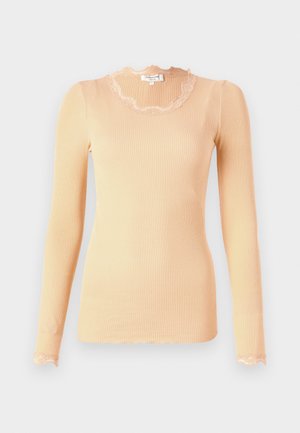 Peach ribbed long-sleeve top with a scalloped lace neckline and hem. Soft texture, fitted silhouette. Lightweight fabric.