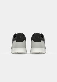 Black and gray athletic shoes with a textured fabric upper, padded collar, and white midsole; features 'CLAE' branding on the heel.