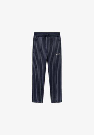 Marineblaue Hose mit weißen vertikalen Nadelstreifen, schwarzem elastischem Bund mit Kordelzug und "LES DEUX" Aufdruck am rechten Oberschenkel.