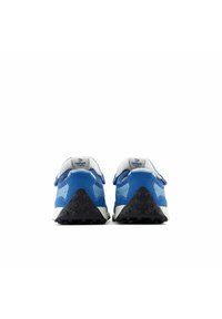 Pari sinisiä ja vaaleansinisiä tennareita, joissa on valkoiset pohjat, näkyy takaapäin valkoista taustaa vasten. Kengissä on mustat teksturoituja kantapään pidikeosat.