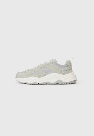 Jasnoszare sneakersy z teksturowanym zamszem i panelami z siateczki, białe sznurowadła, gruba biała podeszwa o zakrzywionym kształcie oraz pętla na pięcie.