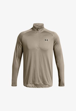 Beige Langarmhemd mit Stehkragen und Viertelreißverschluss, aus glattem Stoff, mit kleinem schwarzem Logo auf der Brust.