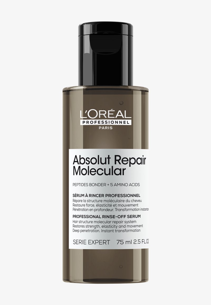75 ml brun flaska med svart pump-top; vit och svart textetikett. Produktnamn: "Absolut Repair Molecular", beskrivning av hårreparation.
