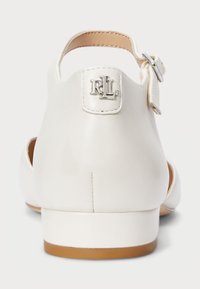 Vit lädersandal med låg klack, justerbart ankelsnöre och RL-logotypdetalj på baksidan; slät textur och minimalistisk design.