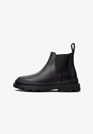Stivaletti Chelsea in pelle nera con pannelli elasticizzati sui lati, tassello di prelievo e suola robusta. Design semplice con texture liscia e cuciture a contrasto.
