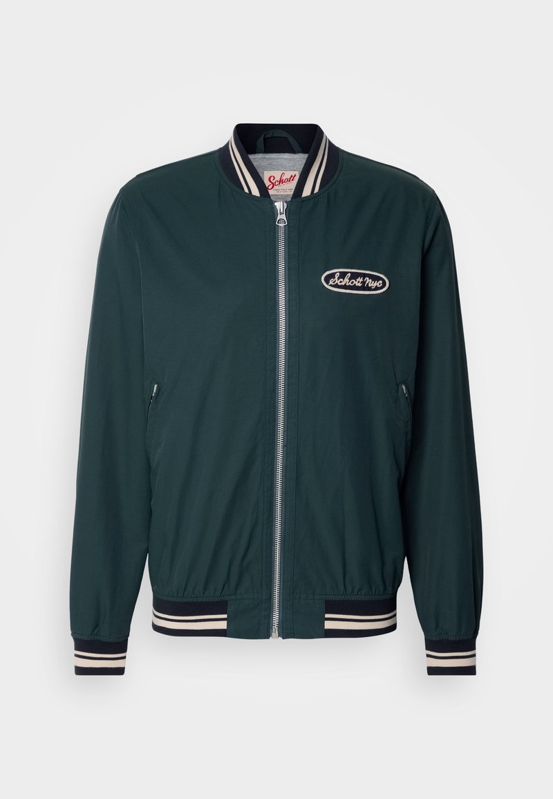 Veste bomber vert foncé avec col et poignets côtelés, dotée d'une fermeture éclair à l'avant et d'un patch logo blanc sur la poitrine. Texture de tissu lisse.