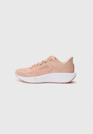 Light pink athletic shoe with mesh upper, white sole, and subtle accents. Features laces and textured details for support and breathability.