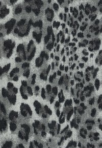 Gray fabric with a textured leopard print pattern in black and dark gray hues, showcasing varied sizes of spots across the material.