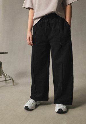Next, REGULAR FIT - WIDE LEG JOGGERS . - Pantalon de survêtement - black