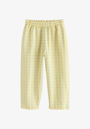 Gule bukser med elastik i taljen med et blåt og hvidt ternet mønster og små hjerteformer, vist på en hvid baggrund.