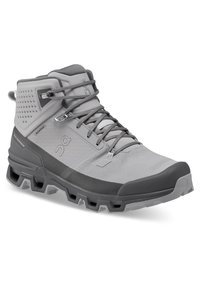 Gray mid-cut hiking boot with textured upper, reinforced heel, and durable rubber sole featuring distinct traction lugs. Adjustable lacing system.