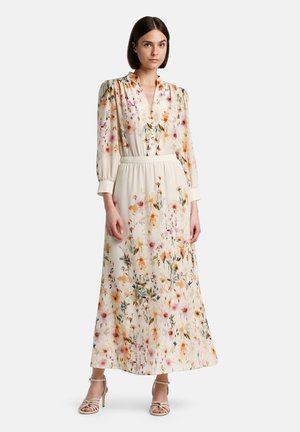 Rochie maxi de culoare crem, cu imprimeu floral colorat. Are mâneci lungi, umăre plisați, decolteu în V și talie elastică. Accentuata cu un bretele.