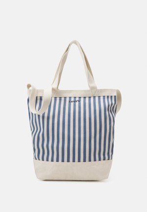 Sac fourre-tout en toile avec des rayures verticales bleues et blanches, poignées beiges et bandoulière réglable.