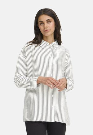 Striped white button-up shirt with a collar, featuring vertical black stripes, long sleeves, and a relaxed fit. Subtle texture evident.