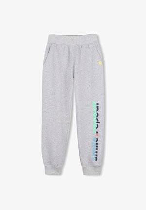 Lichtgrijze joggingbroek met elastische taille en boorden, zijzakken en de tekst "smile . repeat" verticaal gedrukt op één been.