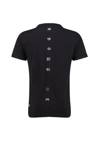 Camiseta de algodón negra con texto vertical en blanco que dice "SOBRE MÍ" en la parte trasera, con pequeños acentos rojos y blancos cerca del dobladillo.