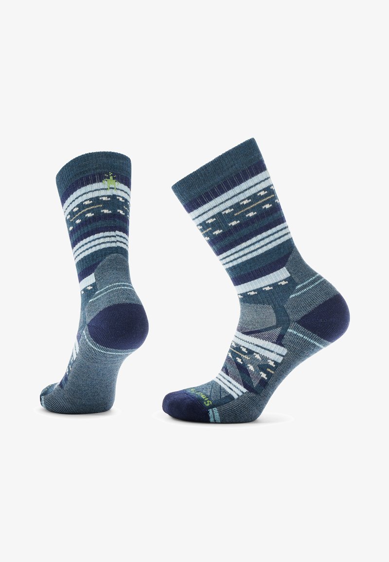 Knit socks featuring a dark blue and teal geometric pattern with stripes and accents. Soft fabric with reinforced toe and heel details.