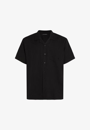 Fekete rövid ujjú ing gombos nyakkal, egyetlen mellzsebbel és öt elülső gombbal. Könnyű anyagból készült.