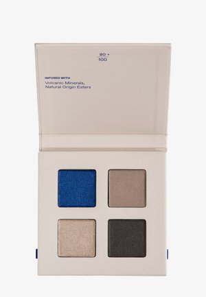 Eyeshadow palette with four square shades: metallic blue, taupe, light shimmer beige, and dark charcoal gray in a beige compact.