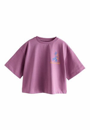 Purple oversized T-shirt made of cotton, with short sleeves and a round neckline. Features colorful "Croissant Club" graphic on the front.