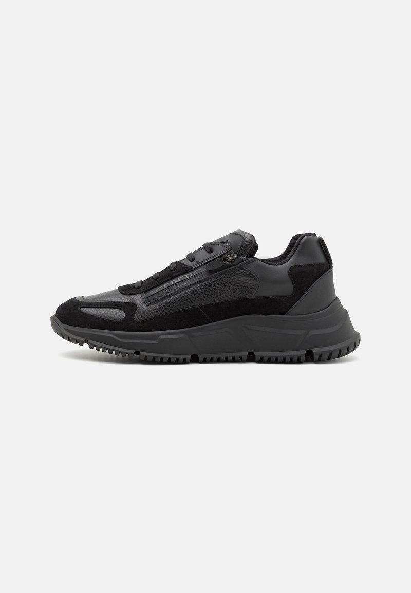 Black athletic shoes featuring a mixed material design with suede and mesh, a textured surface, round toe, and a thick rubber sole.