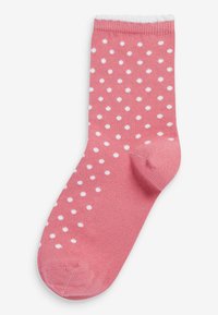 Rosa Baumwollsocke mit weißen Punkten, geripptem Bündchen und verstärktem Zeh. Glatte Textur, standardisierte Knielänge.