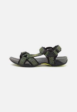 Black and green patterned sandals with adjustable straps, textured sole, and a rounded toe design. Lightweight with a textured footbed.