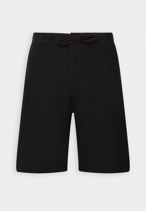 Pantaloni neri realizzati in un tessuto morbido e liscio. Presentano un elastico in vita con coulisse e gamba dritta. Design minimalista, senza motivi.