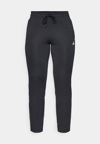 Calças de treino pretas feitas de material suave, com uma cintura ajustável por cordão, pernas ajustadas e um pequeno logótipo branco em destaque.