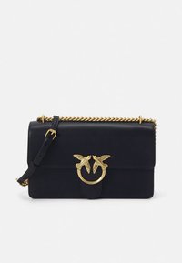Navy leather handbag with a gold chain strap, featuring a round clasp adorned with two birds and a textured surface.