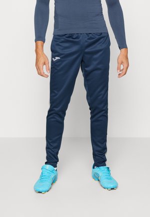 Pantalones deportivos en color navy, confeccionados con una tela suave y ligera, con una cintura elástica. Presentan un logo plateado en el muslo izquierdo y un diseño entallado.
